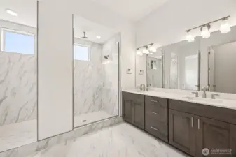 Primary bathroom with walk-in shower. Photos are of a different home. Standard finishes and features are similar and can be modified.
