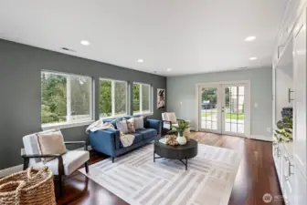 Living Room Facing Deck – The living room features French doors that open to the back deck, allowing natural light to fill the space and seamlessly connecting indoor and outdoor living.