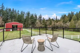 Primary Bedroom Balcony – Step outside onto the private balcony and enjoy quiet views of the surrounding land and natural setting.