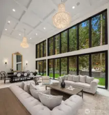 Great room with coffered ceilings and two elegant chandeliers