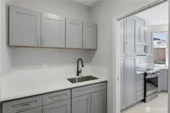 Laundry with cabinets and sink