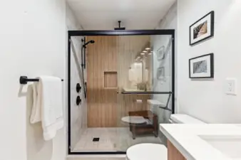 Huge primary shower is ideal! Wood accents showcase the thought to detail in the home.