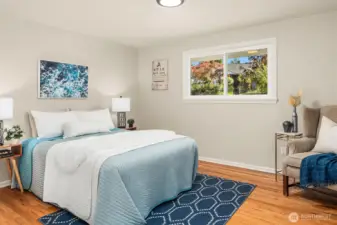 First guest bedroom is very spacious and looks out onto the peaceful neighborhood. Gorgeous oak hardwoods have been refinished. Picture from previous listing.