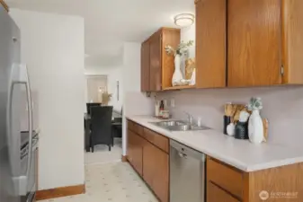 Galley kitchen with stainless sink and dishwasher, walks out to formal dining room