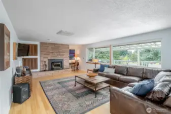 Enjoy the fun vibes of this living room with a wood burning fireplace and plenty of windows to bring the light in!