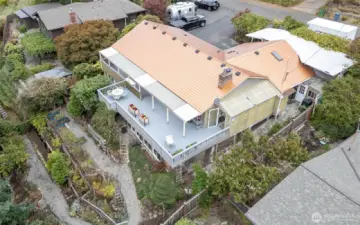 The terraced backyard is home to mature plants, fruit trees and garden beds.