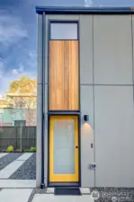 Vertical cedar siding defines the exterior with warmth and texture, setting the architectural tone.