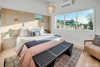 Custom sustainably built accent wall using reclaimed materials features built in night stands and sconces for the perfect retreat.