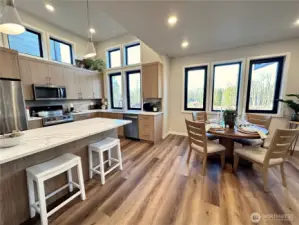 Large kitchen with great island, transom windows, dining space and lovely natural light throughout.