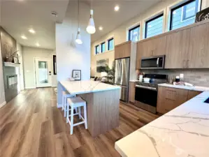 Quartz counters, stainless appliances and custom lighting