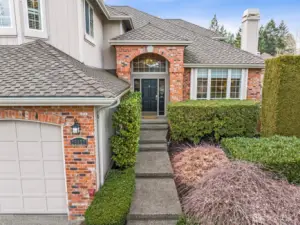 Steps lead up to the front door, and to the right there is a camelia hedge with 3 different STUNNING colors that will be in bloom in April! There are hidden suprises for the Spring throughout this yard!