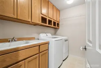Laundry room with superior storage and a door. You don't have to walk through the laundry from the garage to get into the house.  Washer & Dryer stay!