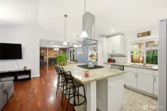 Open-concept layout flows seamlessly from the living area into the dining and kitchen.