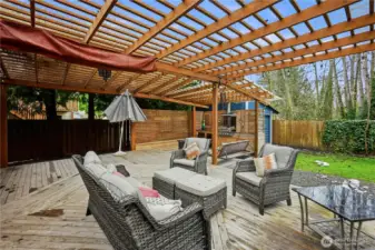 Expansive outdoor living area under a wood pergola, ideal for year-round entertaining.