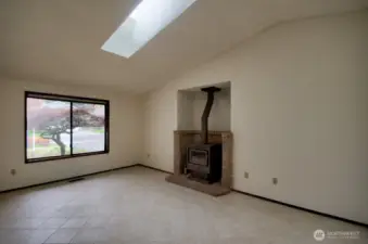Large living room with wood fireplace.