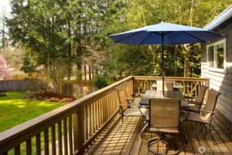 Expansive deck off kitchen/dining with stairs to backyard.