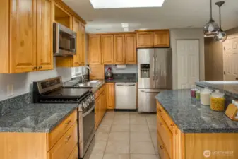 Main Floor Kitchen with brand new high end gas range, soft close cabinets, granite countertops.