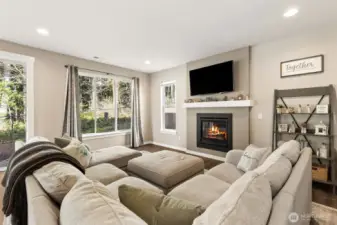 Cozy fireplace in living room with lots of windows