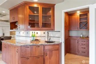Butler's pantry with sink and below to the left of the sink is the pull-out refrigerator/freezer.