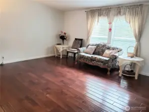 Another Different View of the Huge Living Room Showing Hard Wood Flooring, Newer Paint and Trim.