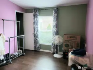 Another Picture of the A good Sized Third Bedroom with Hard Wood Flooring and Trim Showing the Walk In Closet.