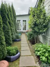 Side View of the Home Showing Stepping Stone Walk Way to the Covered Porch Front Room Entry.