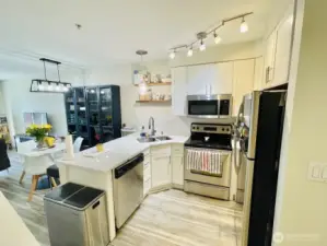 Open concept kitchen with plenty of light a great cooking triangle and stainless steel appliances