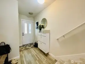 Entrance, headed out to front porch, passing kitchen & main floor bedroom, heading out to garage.