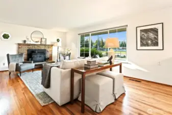 Living room with freshly refinished hardwoods throughout  main! Wood burning fireplace