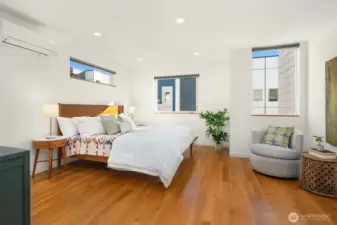 Huge primary bedroom with walk-in closet and modern bathroom.
