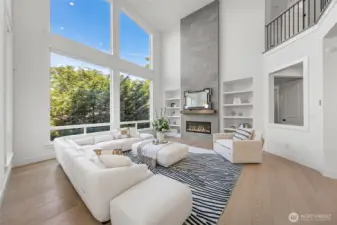 Gas fireplace with beautiful floor-to-ceiling tile surround and built-in shelves.