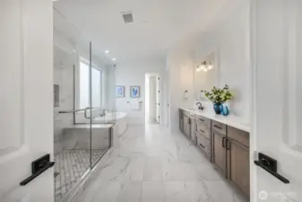 Luxurious primary bath with in-floor heating, large walk-in shower with double shower heads, and double-vanity.