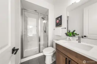 Private bath off the 2nd guest suite on upper level.