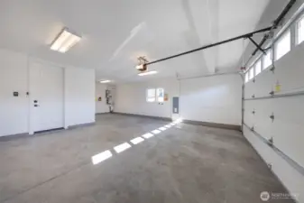 Two-car attached garage with extra storage space and EV charging outlet.