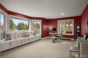 Versatile room with built-in seating + storage and large windows for natural light.