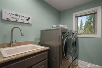 Laundry and utility room with washer/dryer and extra storage space.
