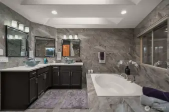 Luxury spa-inspired primary bathroom with soaking tub, dual vanities, and elegant finishes.