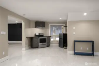 Convenient lower-level kitchenette with cabinetry and prep space.