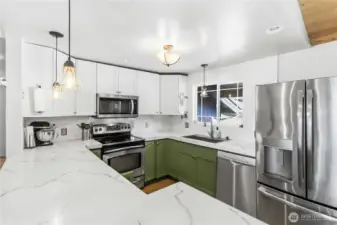 Updated kitchen with custom concrete counters and all stainless appliances.