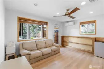 Downstairs bedroom/living area with patio access & mini-split.