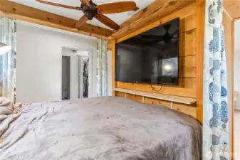 Bed behind desk area.