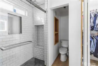 Downstairs bathroom with tile shower & walk in closet.