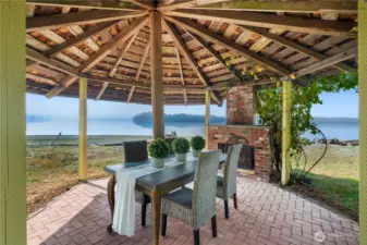This waterfront gazebo invites with a brick fireplace offers a truly special place to dine, gather, and enjoy the peaceful no-bank shoreline.