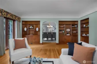 Original built-ins and arched transition to the dining room speak to the thoughtful craftsmanship and timeless design of the home.