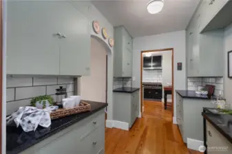 Rich in utility and charm, the butler’s pantry offers generous built-ins, quality finishes, and seamless connection to the updated kitchen. Original cabinets, hardware, and a built-in step to reach the top cabinet!