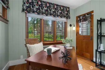 A cozy workspace framed by classic windows and original trim adds charm and versatility to the home.