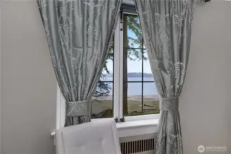 PBR - A window seat with views of Eld Inlet brings a quiet waterfront connection to the primary bedroom.