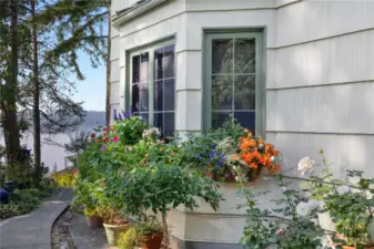 Colorful gardens and curated outdoor spaces reflect the relaxed elegance found throughout this special property.