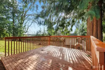 Lower deck overlooking the beautifully landscaped with pruned flowering trees, indigenous, hardy plants, and effortless greenery.