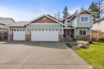 Welcome home! Extra large driveway with gates to the back on the left